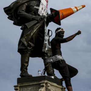 Protests Continue At Capitol In Denver In Aftermath To Death Of George Floyd DENVER, CO - MAY 31: A man who taped himself to a Civil War monument in front of the Colorado State Capitol raises his fist in the air during the fourth consecutive day of protests in the aftermath of the death of George Floyd on May 31, 2020 in Denver, Colorado. The city of Denver enacted a curfew for Saturday and Sunday nights in hopes of curbing destructive protests that have wreaked havoc across the city. (Photo by Michael Ciaglo/Getty Images)